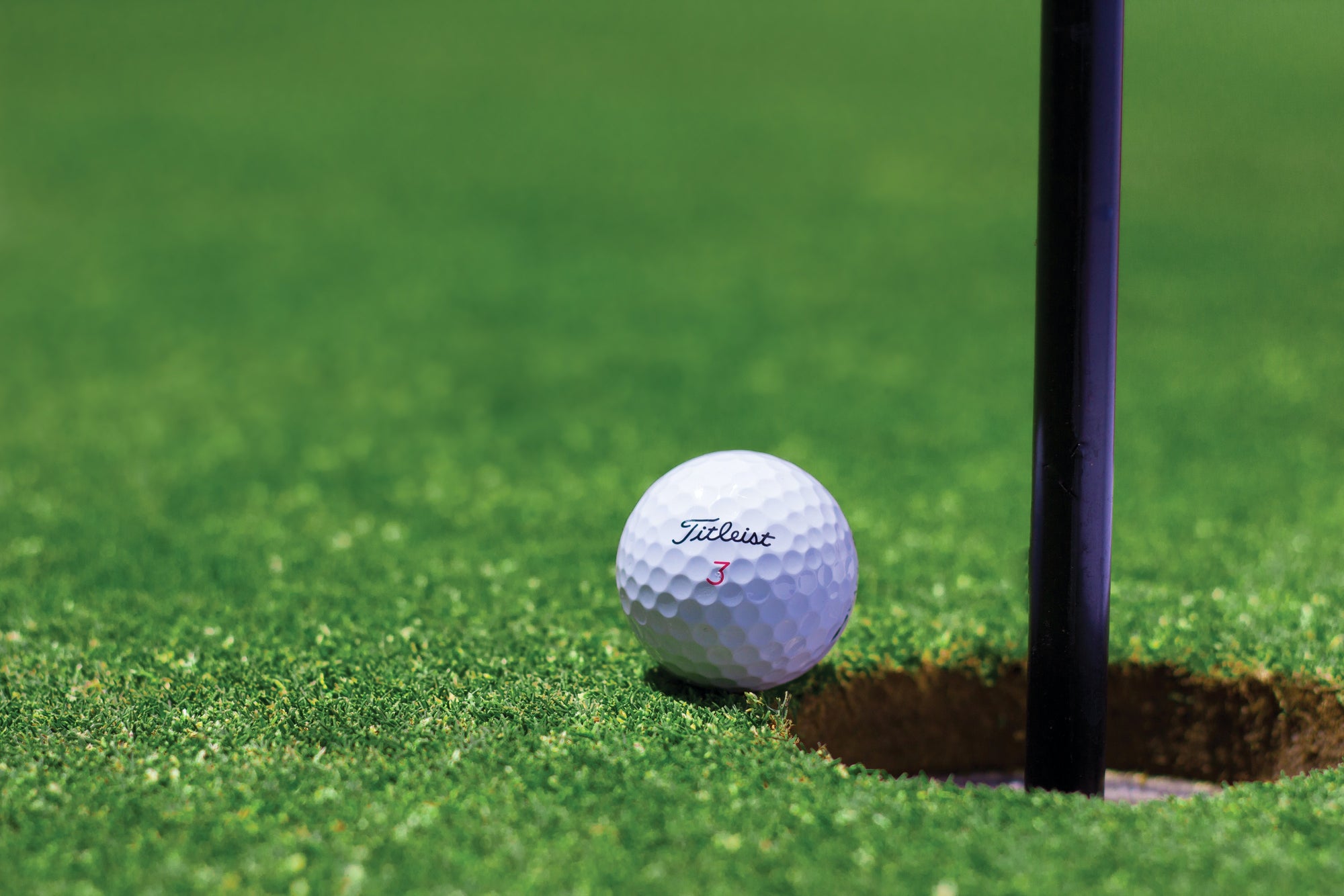 Titleist pro v1 golf ball. Titleist pro v1 X golf ball being used on the putting green. 